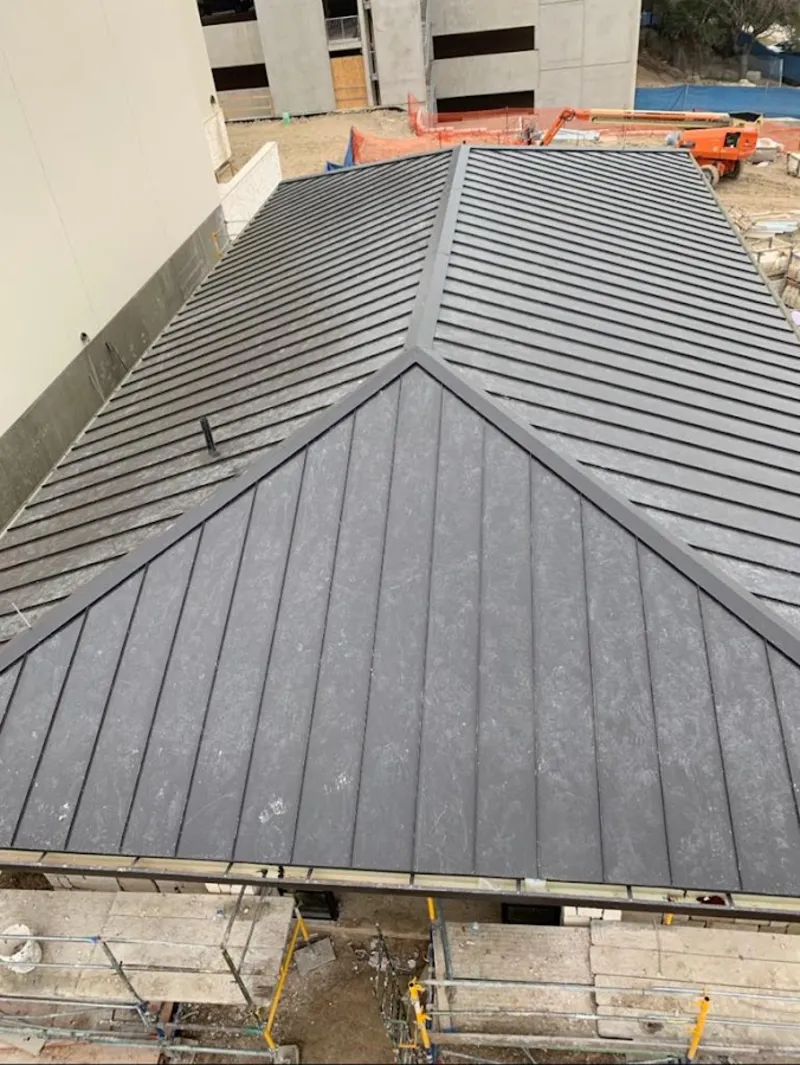 Commercial metal roof construction with crane equipment in Mount Holly